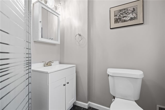 bathroom featuring vanity and toilet