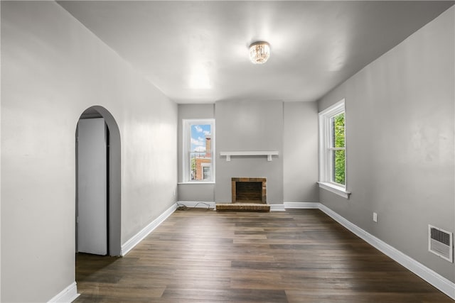 unfurnished living room with a fireplace and dark hardwood / wood-style floors