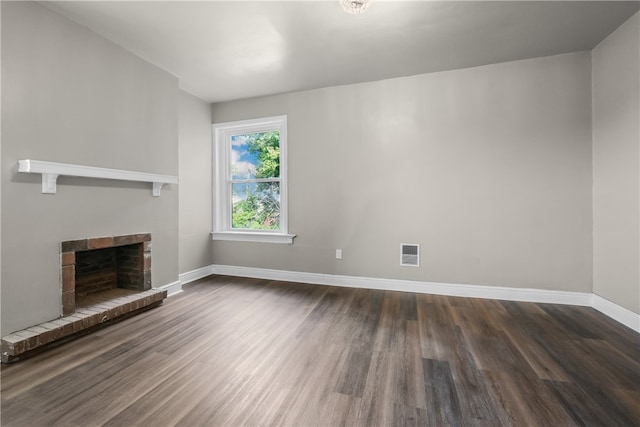 unfurnished living room with dark hardwood / wood-style floors