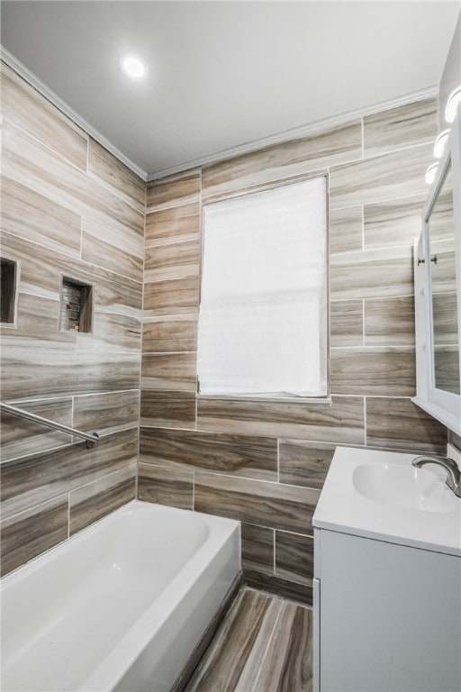 bathroom with a bathing tub, vanity, and wood-type flooring