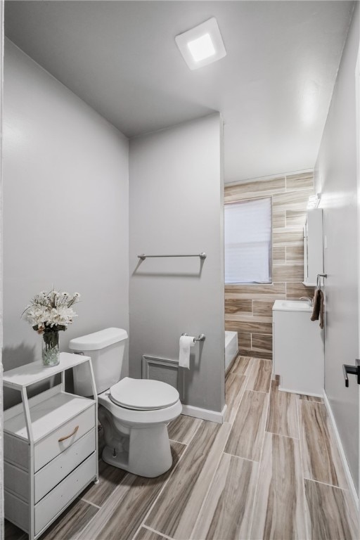 bathroom with hardwood / wood-style floors and toilet