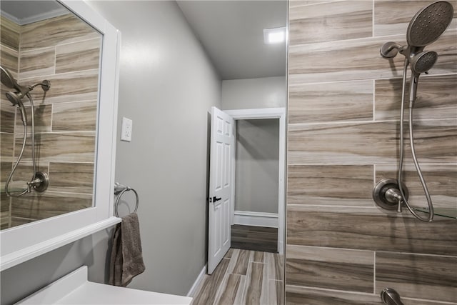 bathroom featuring a tile shower and hardwood / wood-style flooring