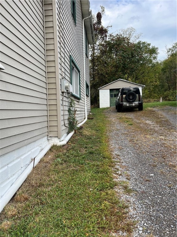 view of home's exterior featuring an outdoor structure and a garage