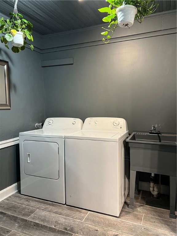 washroom featuring hardwood / wood-style flooring and washer and dryer