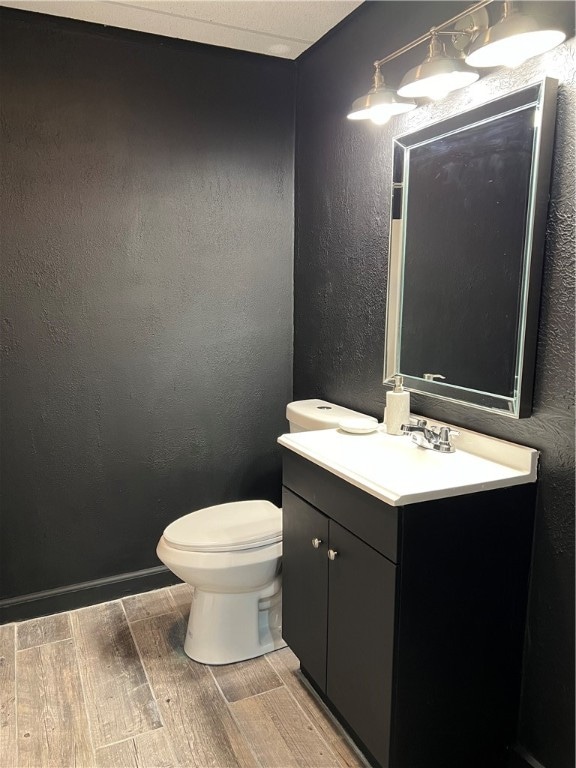 bathroom with vanity, hardwood / wood-style floors, and toilet