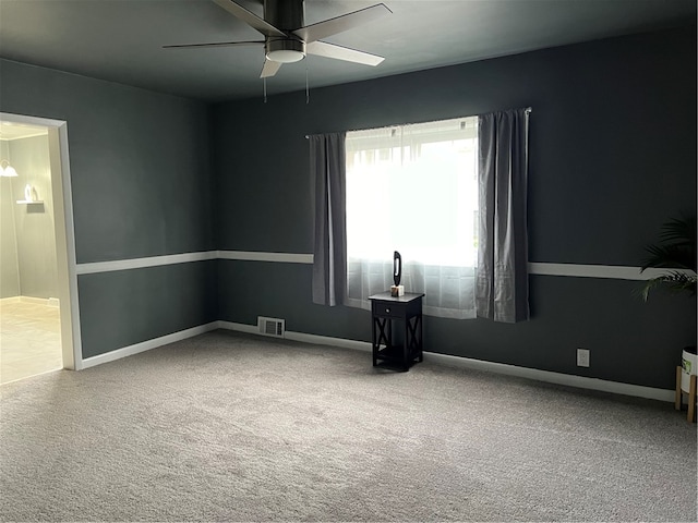 spare room featuring ceiling fan and carpet floors