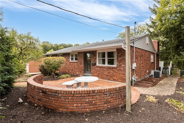 view of front of home with central AC unit and a patio area