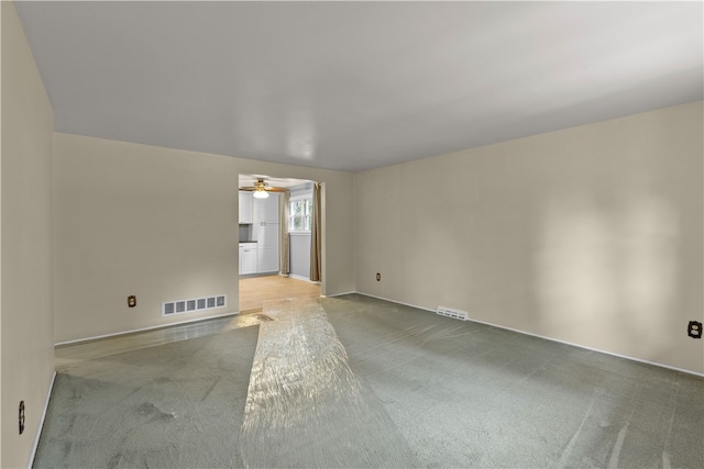 unfurnished room with ceiling fan and light colored carpet