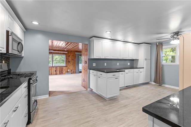 kitchen featuring ceiling fan, stainless steel appliances, light hardwood / wood-style floors, and white cabinetry