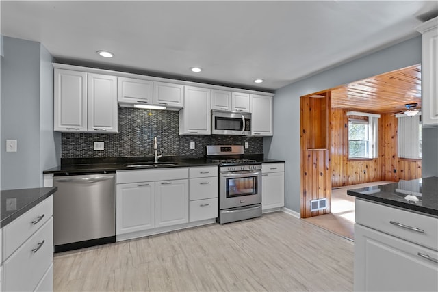 kitchen with light hardwood / wood-style floors, stainless steel appliances, sink, and white cabinetry