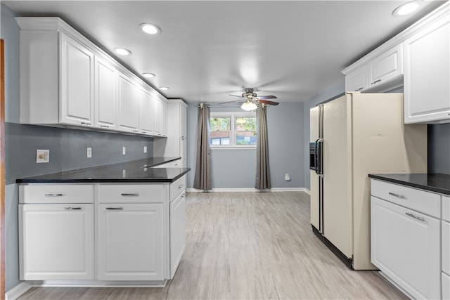 kitchen with light wood-type flooring, white cabinetry, ceiling fan, and white refrigerator with ice dispenser