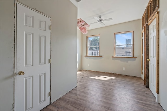 unfurnished bedroom with light wood-type flooring and ceiling fan