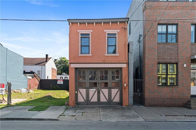 622 Emlin St, East Allegheny, PA 15212 - view of front of house featuring brick siding, a garage, driveway, and a front lawn