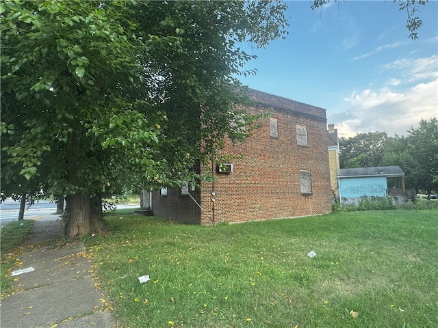 view of side of home featuring a yard