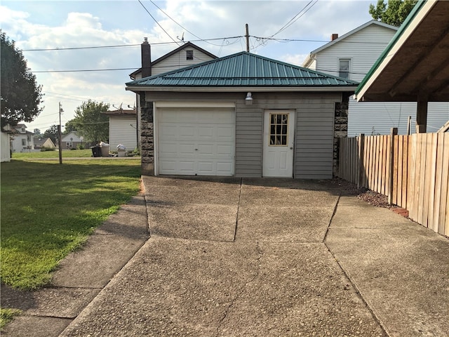 garage featuring a lawn