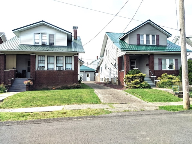 bungalow with cooling unit, a front yard, and a porch