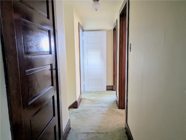 hallway featuring light colored carpet