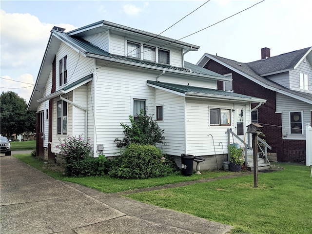 view of side of property with a yard