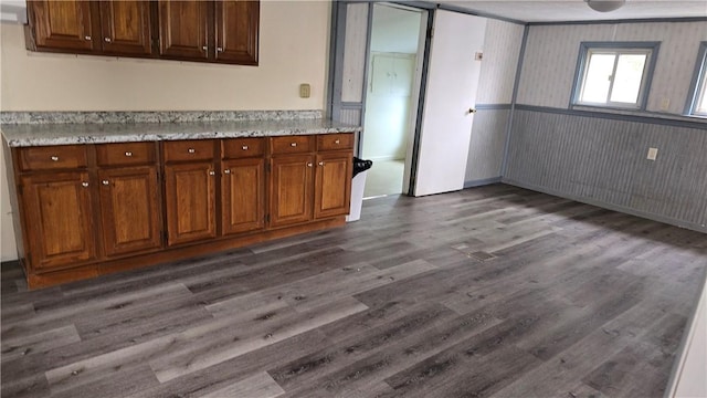 kitchen featuring brown cabinetry and dark wood-type flooring
