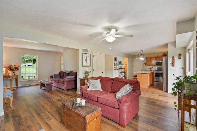 living room featuring hardwood / wood-style floors and ceiling fan