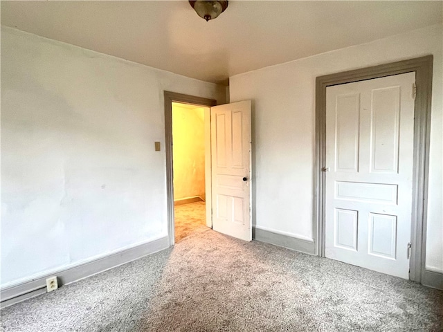 unfurnished bedroom with light colored carpet