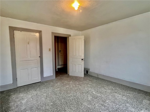 unfurnished bedroom with carpet floors and a textured ceiling