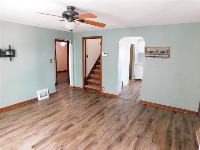 spare room with dark hardwood / wood-style flooring and ceiling fan