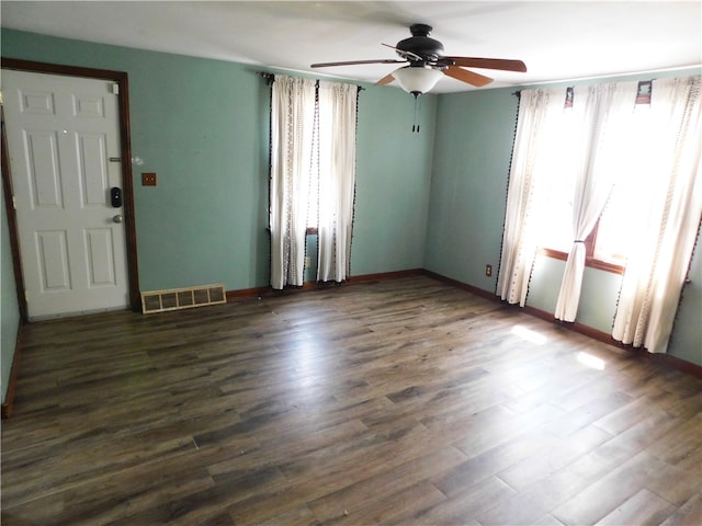 unfurnished room with dark hardwood / wood-style floors and ceiling fan