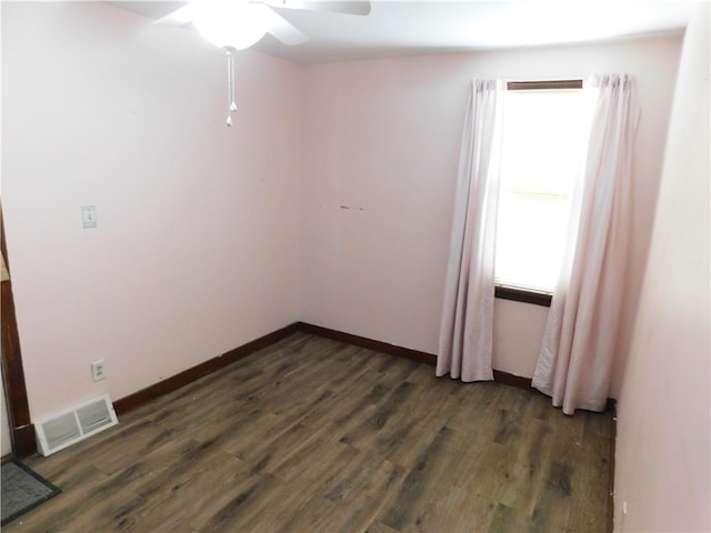 empty room featuring ceiling fan and dark wood-type flooring