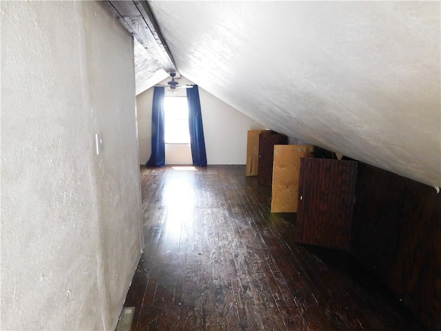 additional living space with lofted ceiling with beams and dark hardwood / wood-style flooring