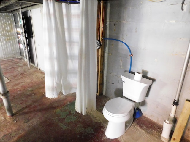 bathroom with concrete flooring and toilet