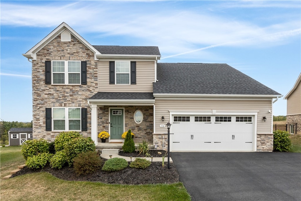 view of front of home featuring a front lawn and a garage