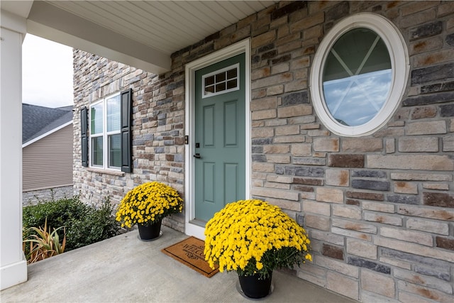 view of exterior entry with covered porch