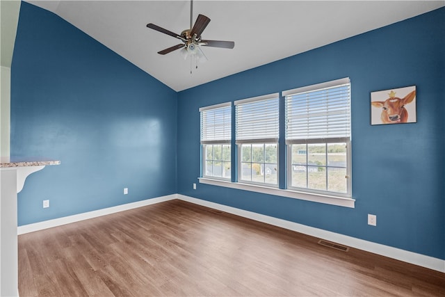 unfurnished room with ceiling fan, lofted ceiling, and hardwood / wood-style floors