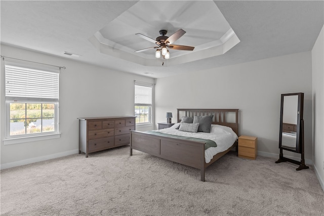 bedroom with multiple windows, light colored carpet, and ceiling fan