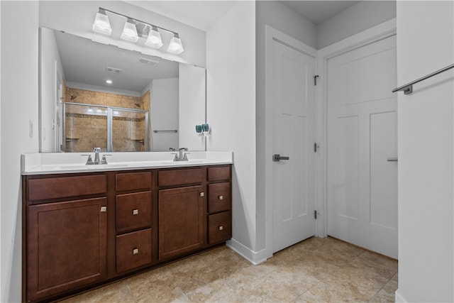 bathroom with vanity and a shower with door