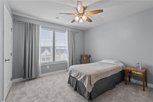 bedroom with ceiling fan and light colored carpet