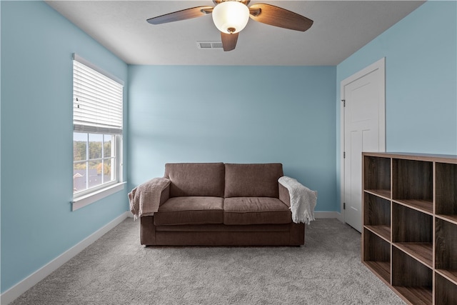 living room with ceiling fan and carpet floors