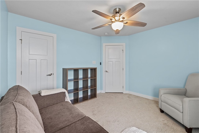 carpeted living room featuring ceiling fan