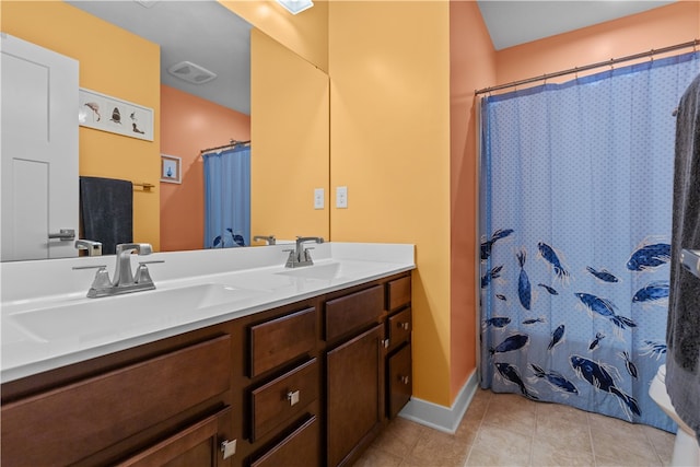 bathroom featuring walk in shower, vanity, and tile patterned flooring