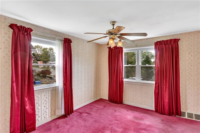 unfurnished room with ceiling fan and carpet flooring