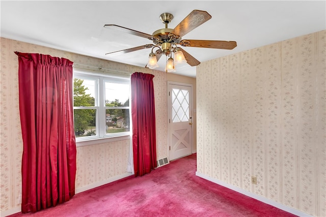 spare room with carpet floors and ceiling fan