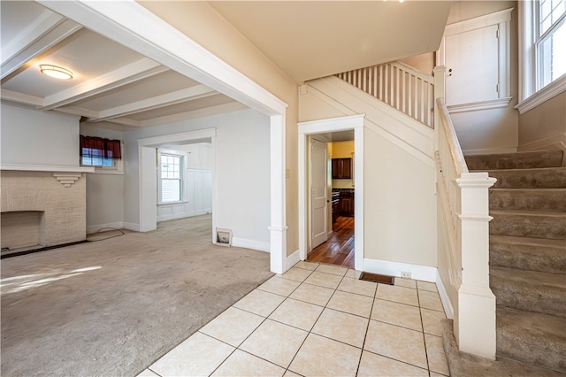 interior space featuring light colored carpet and beam ceiling