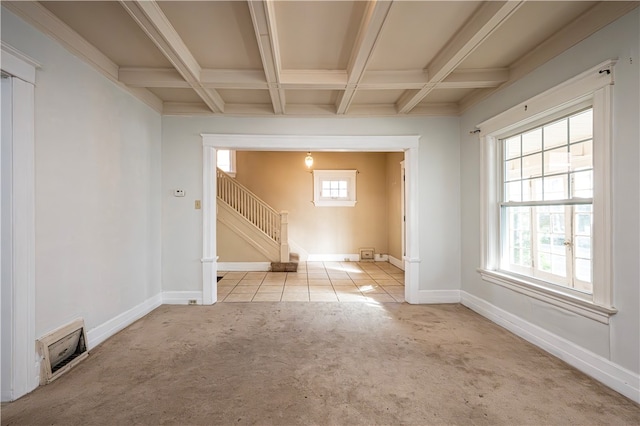 spare room featuring coffered ceiling, beam ceiling, light carpet, and plenty of natural light