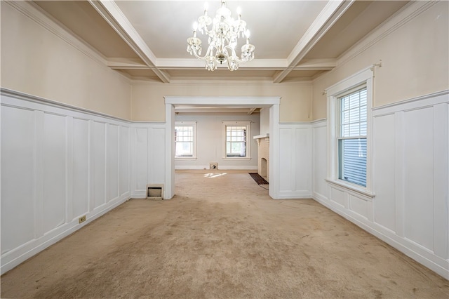 interior space with coffered ceiling, light colored carpet, beamed ceiling, and a chandelier