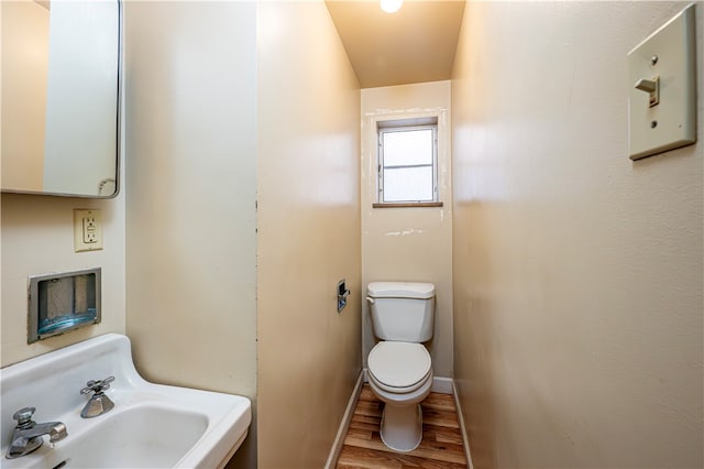 bathroom with wood-type flooring, sink, and toilet