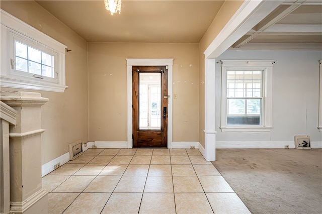 carpeted entryway featuring a wealth of natural light