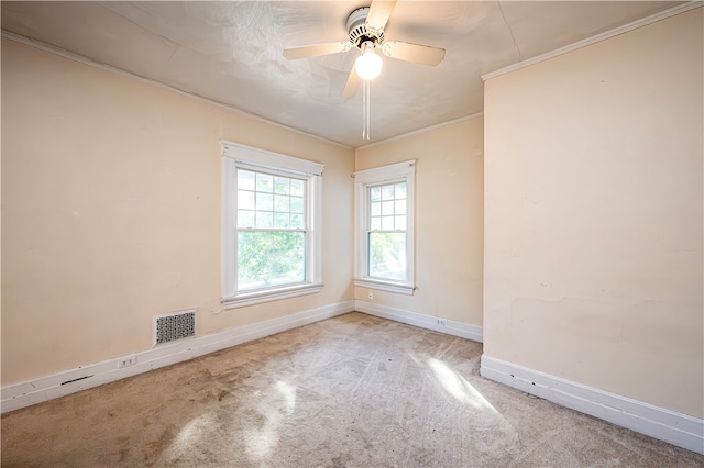 carpeted empty room featuring ceiling fan and crown molding