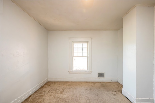 carpeted spare room with crown molding