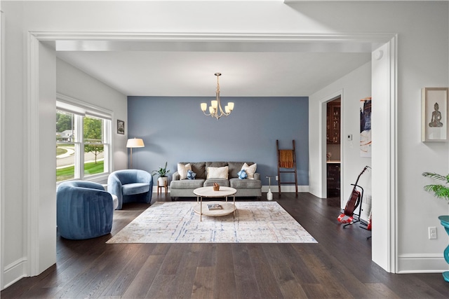 living room featuring an inviting chandelier and dark hardwood / wood-style floors